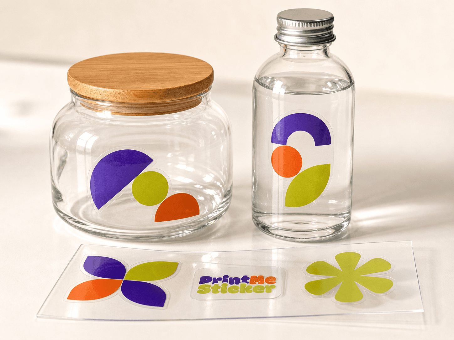 Flat realistic clear PrintMeSticker stickers applied to glass bottles and jars